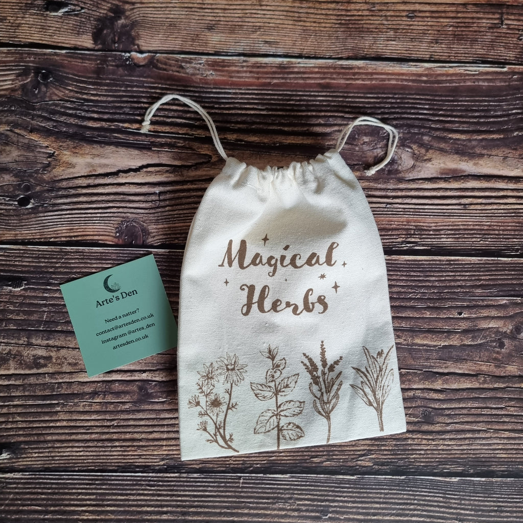 A pale "Magical Herbs" bag with some herb graphics on a wooden background