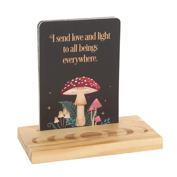 Dark forest themed affirmation cards with wooden stand featuring moon phases. Card pictured states "I send love and light to all beings everywhere."