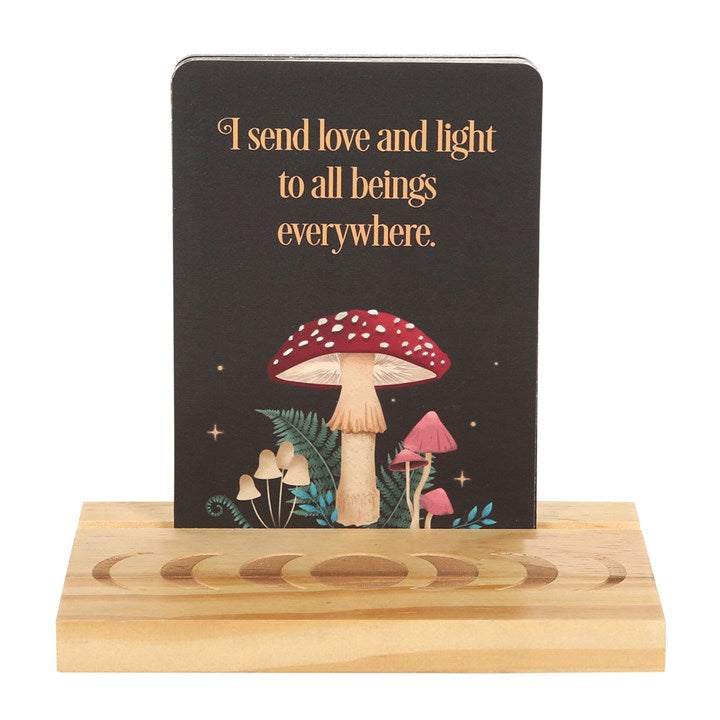 Dark forest themed affirmation cards with wooden stand featuring moon phases. Card pictured states "I send love and light to all beings everywhere."