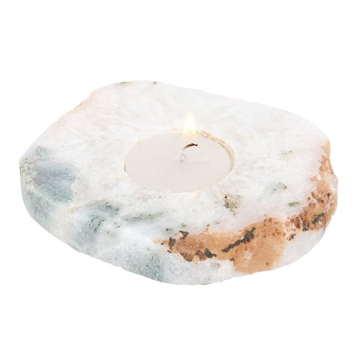 An agate tealight holder with lit candle