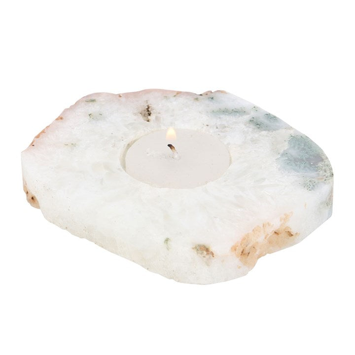 An agate tealight holder with lit candle