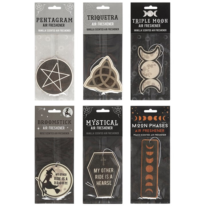 A collection of six different car air fresheners packaged similarly and in various shapes such as a coffin and pentagram with different scents such as peach and vanilla. 