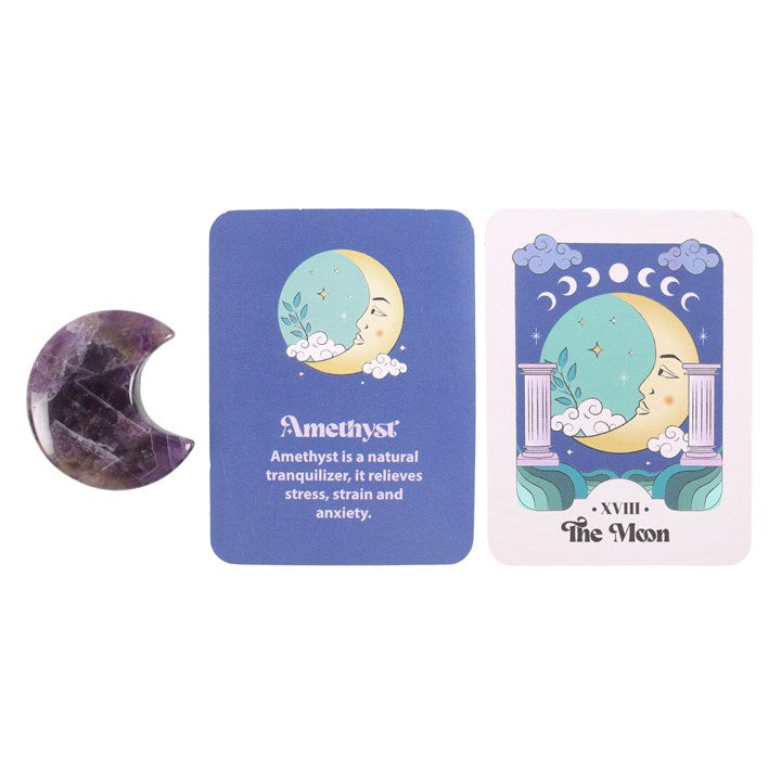 An amethyst crystal moon keepsake stone beside its packaging box, which has 'The Moon' tarot card imagery.