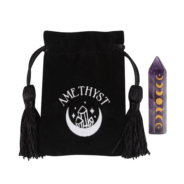An Amethyst crystal point with gold-tone moon phase engraving, accompanied by a matching drawstring bag.