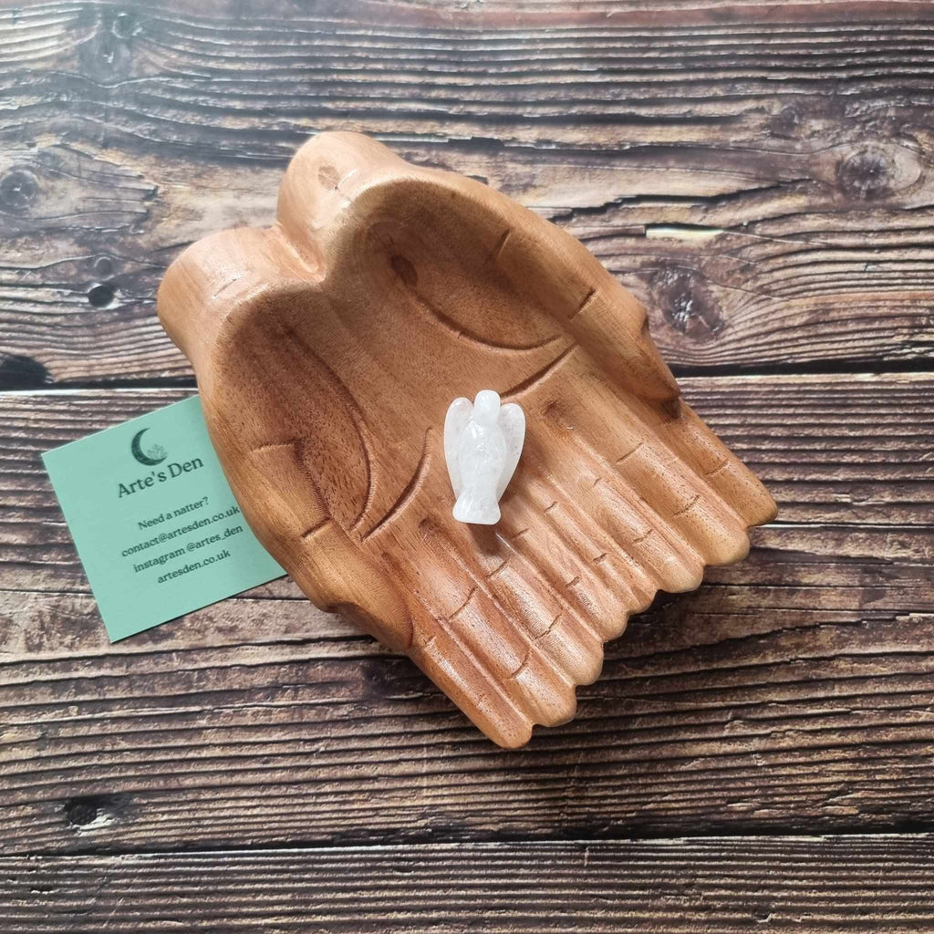A white crystal angel on a wooden backdrop 