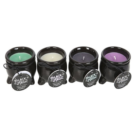 A set of four black cauldron-shaped candles in different colours intended for scenting, each with a label indicating the scent and 'Black Magic' branding.