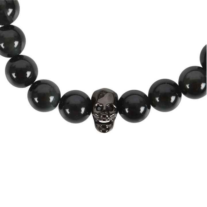 Close up of the Black Obsidian beaded bracelet and stainless steel skull against a white background 