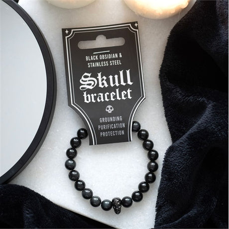Black Obsidian beaded bracelet and stainless steel skull displayed on a black card with the text 'Skull bracelet' and a skull graphic.