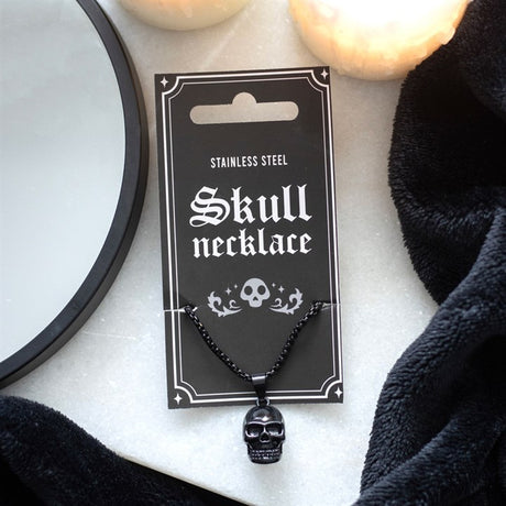 Black stainless steel skull pendant necklace displayed on a black card with the text 'SKULL NECKLACE STAINLESS STEEL' and a skull graphic.