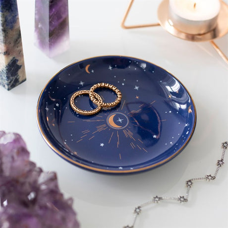 A round blue celestial moon trinket dish with silver and gold details