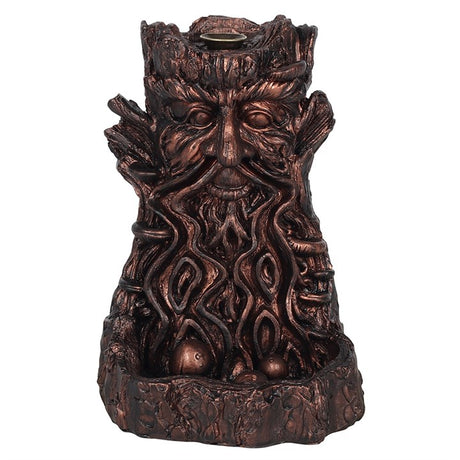 A bronze-looking back flow incense holder in a green man design 