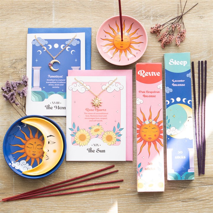 A Celestial Dreams bundle of accessories including sun and moon themed cards, necklaces, incense dishes and incense