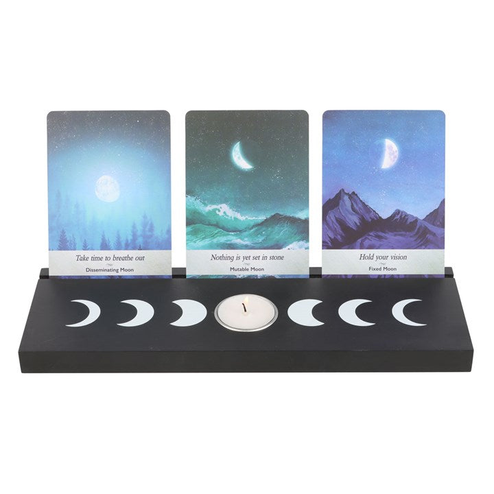 A large black moon phases design tarot and oracle card stand with three cards, displayed on a white background.