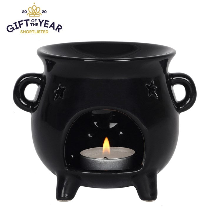 A black cauldron shaped wax burner with a lit tea light inside against a white background