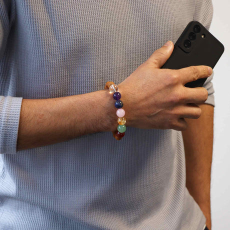 A cedarwood and crystal bead bracelet being worn on a wrist