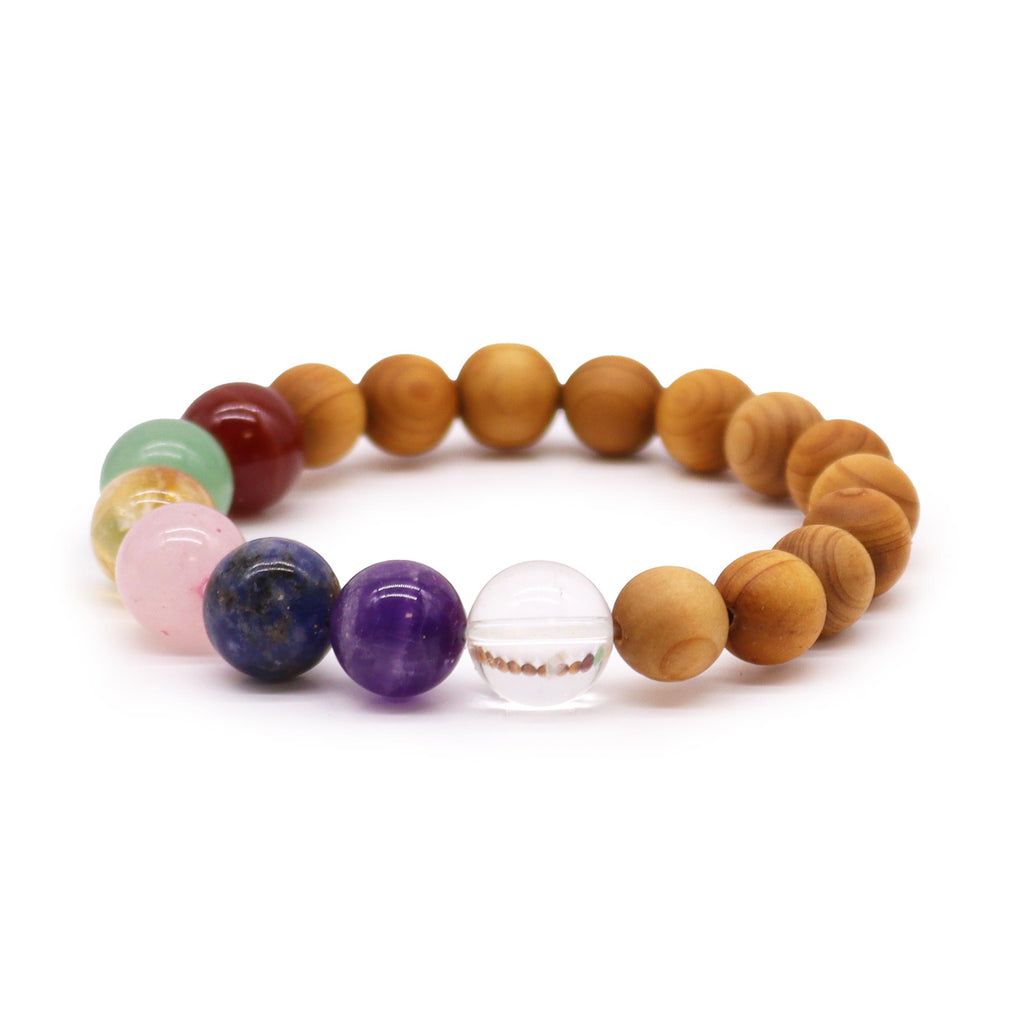 A cedarwood and crystal bead bracelet on a white surface 
