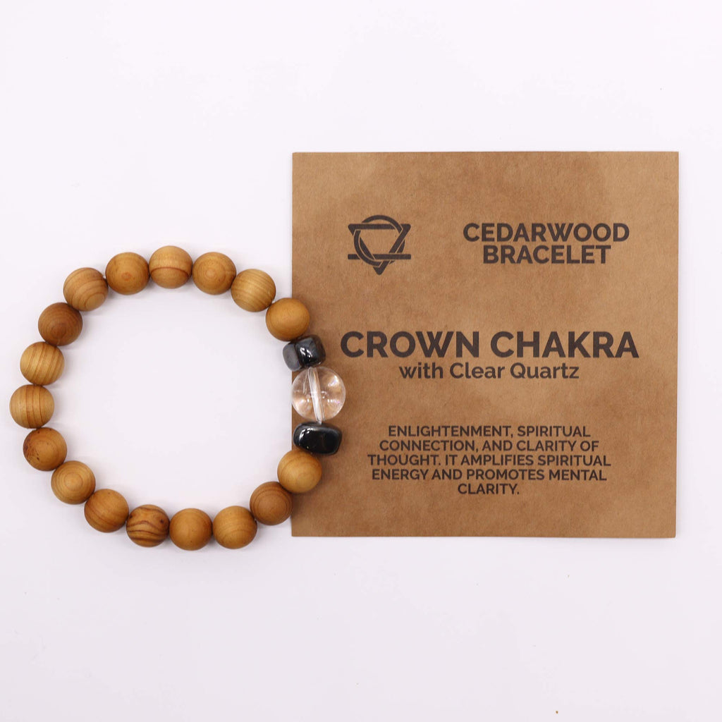 A cedarwood bracelet with a clear quartz bead on a white background with an information sheet
