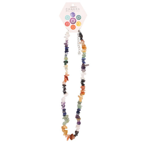 A colourful crystal chipstone necklace displayed on a card, featuring an assortment of crystals representing different chakras.