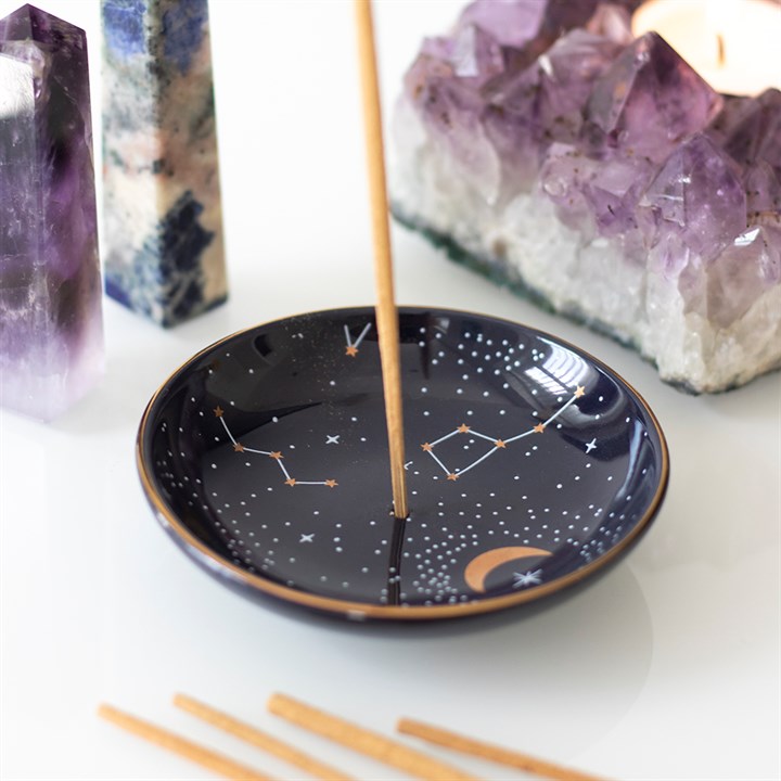 A dark blue zodiac themed incense holder 