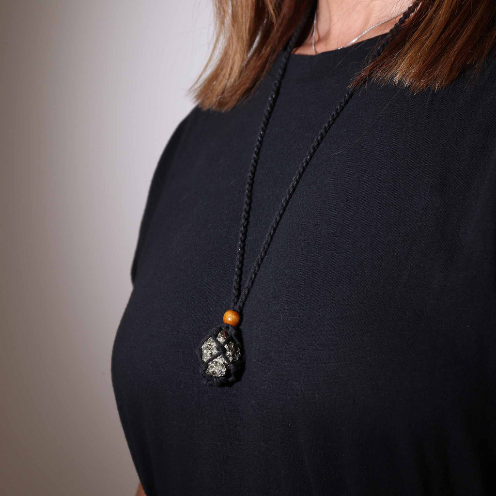 A black-coloured crystal cord necklace with an example crystal inside