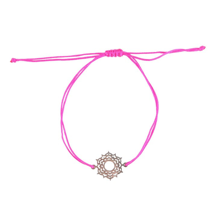 A Crown Chakra charm bracelet with a pink band and a silver charm against a white surface 