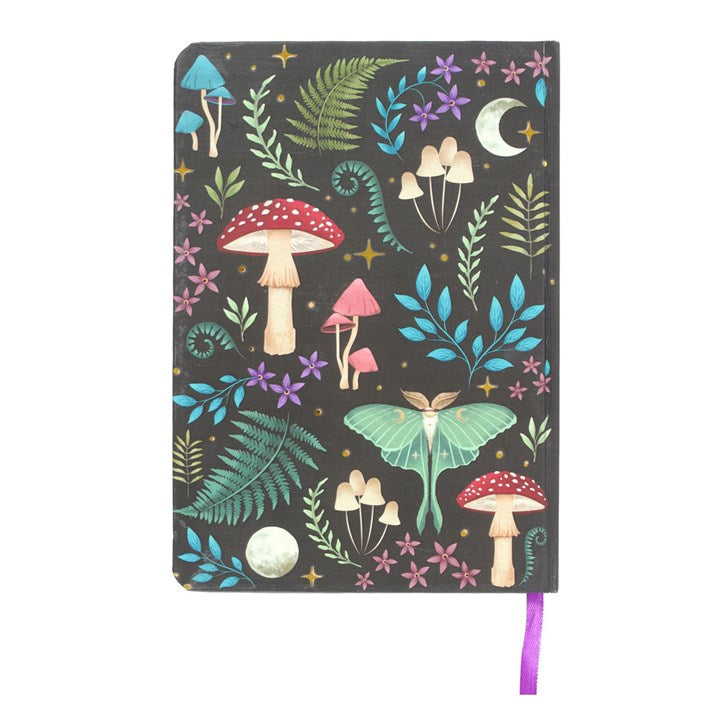 A dark forest mushroom, lunar moth and plant themed A5 notebook on a white surface. 