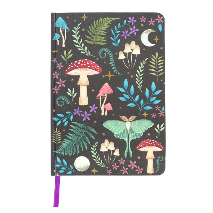 A dark forest mushroom, lunar moth and plant themed A5 notebook on a white surface. 