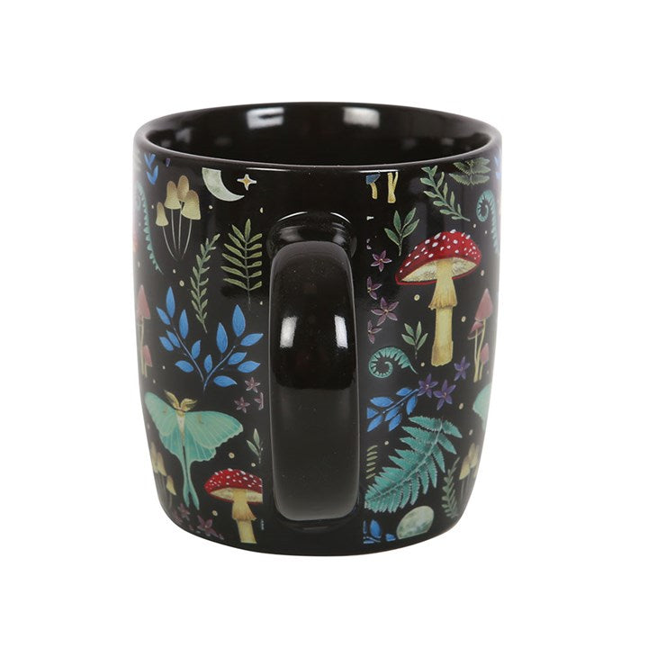 A dark forest, black ceramic mug with a colourful forest and mushroom design, displayed against a white background
