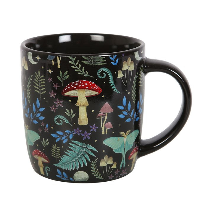 A dark forest, black ceramic mug with a colourful forest and mushroom design, displayed against a white background