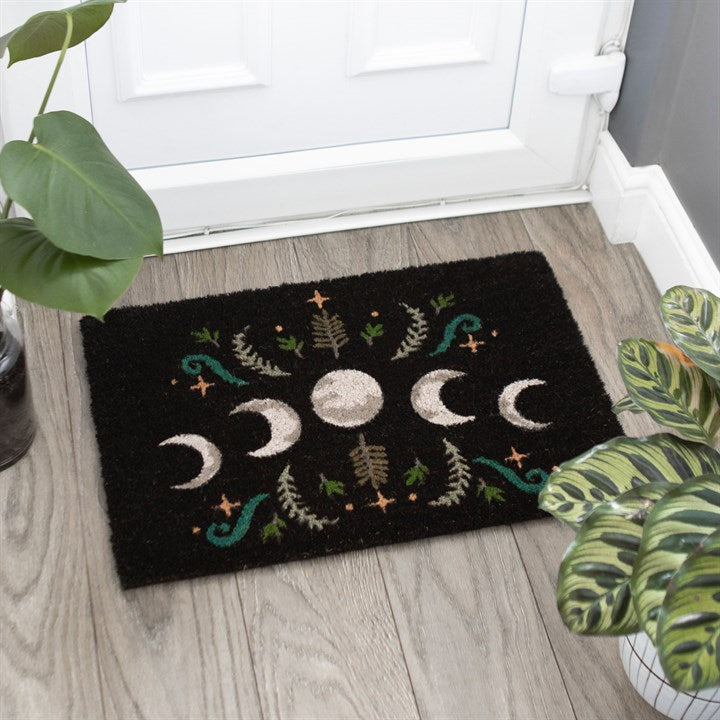 A black doormat with moon phase design 
