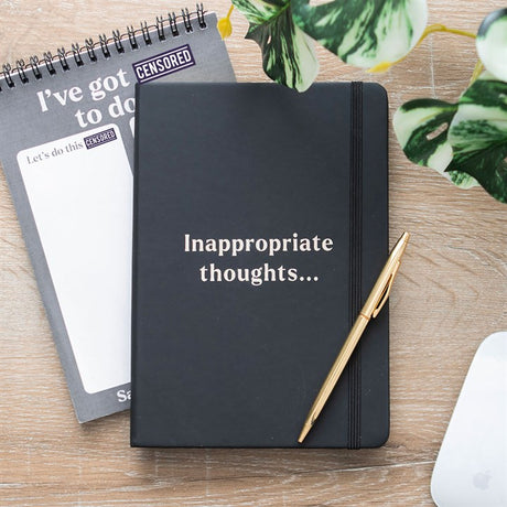 A black lined notebook with the phrase 'inappropriate thoughts'