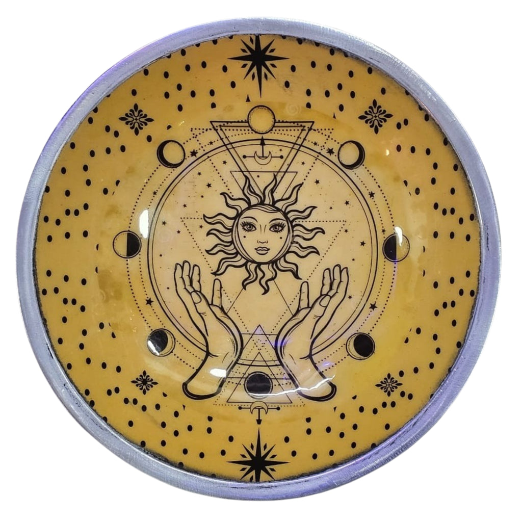 Decorative round offering plate with celestial design featuring sun, moon, and hands on a yellow background.