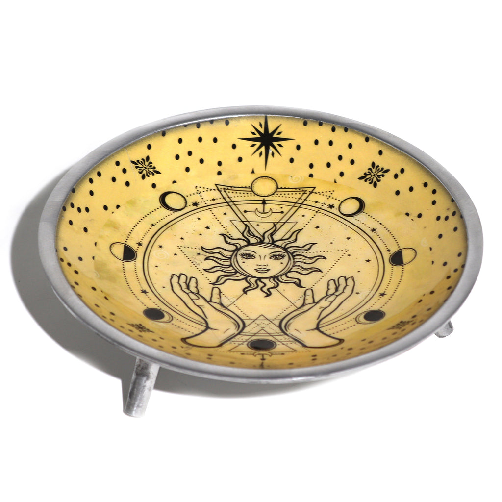 Decorative plate with celestial design featuring hands holding a sun and moon, on a white background.