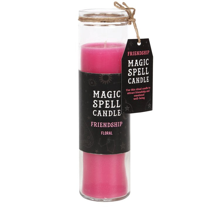 A pink tube candle with a label indicating it's a Magic Spell Candle and contains Floral for Friendship