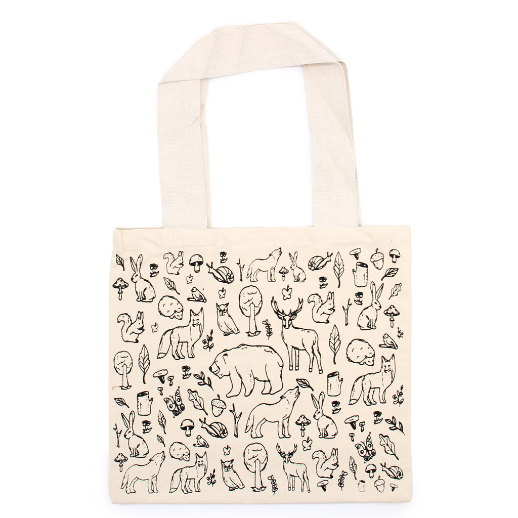 A cream bag which has black lined drawings of various animals such as bears, wolves, hedgehogs, owls, squirrels and some plant life such as acorns, trees and herbs