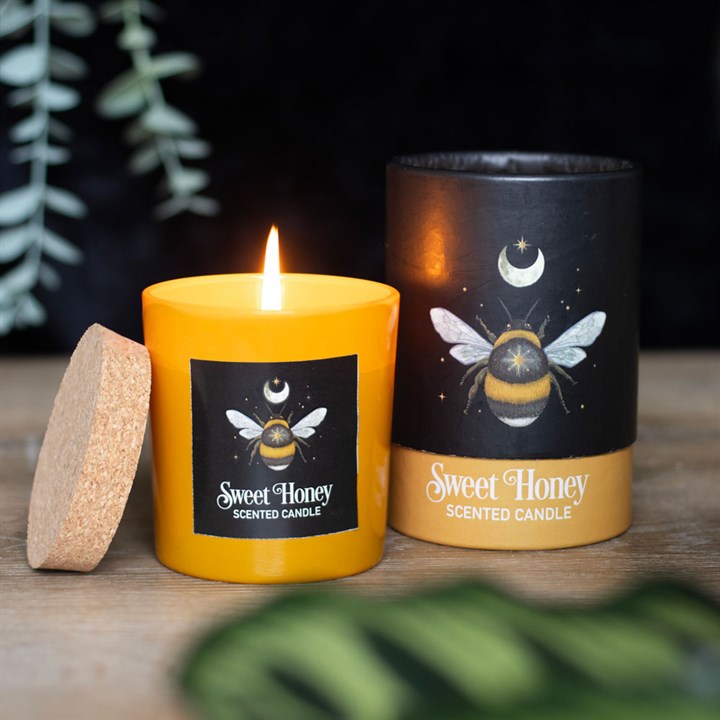 Sweet Honey Scented candle, shown next to its box; both decorated with bee and moon motif 