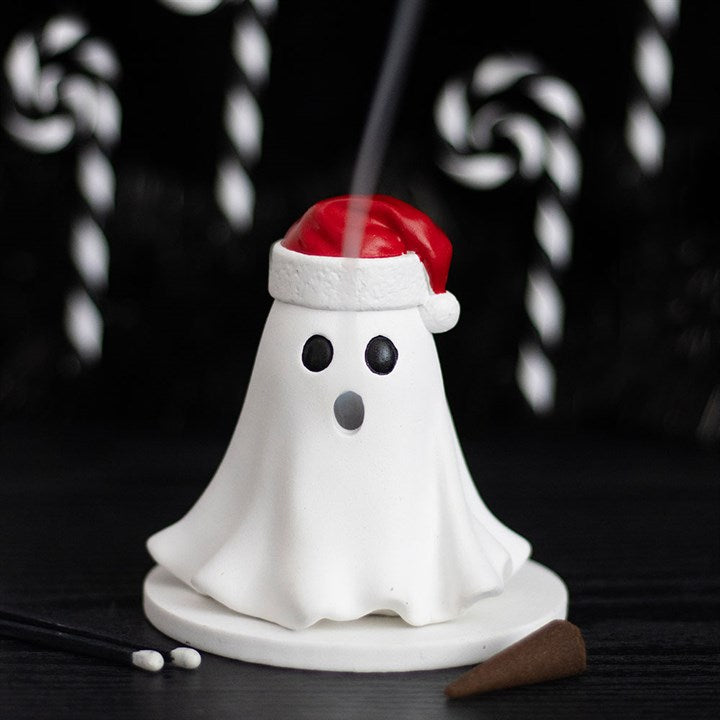 Ghost incense holder wearing a Santa hat with black candy canes in the background