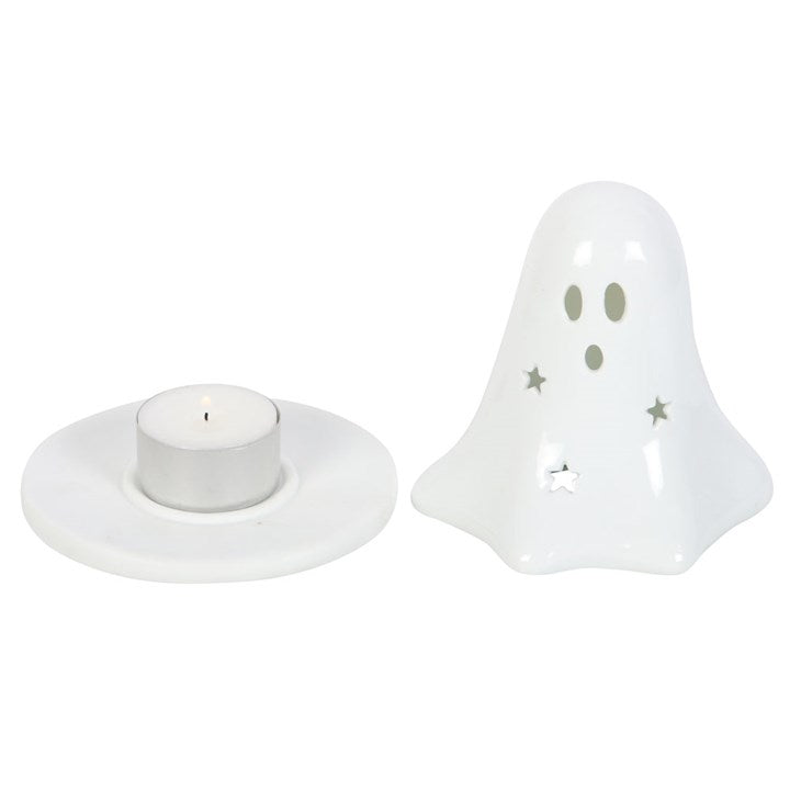 A white ceramic tealight and incense cone holder in the shape of a ghost with which has been taken apart to show a tealight inside, on a white background