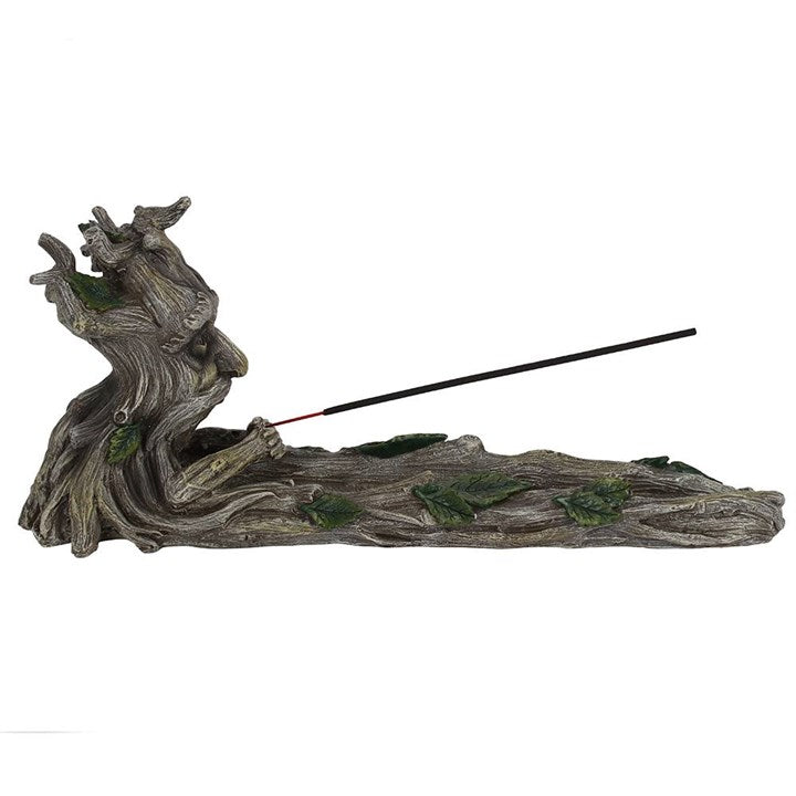 A resin incense holder in the shape of a stylised Green Man character, with leaf patterns for eyes and branches for a mouth and nose.