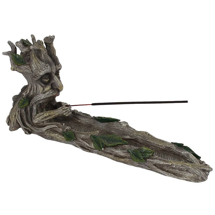 A resin incense holder in the shape of a stylised Green Man character, with leaf patterns for eyes and branches for a mouth and nose.