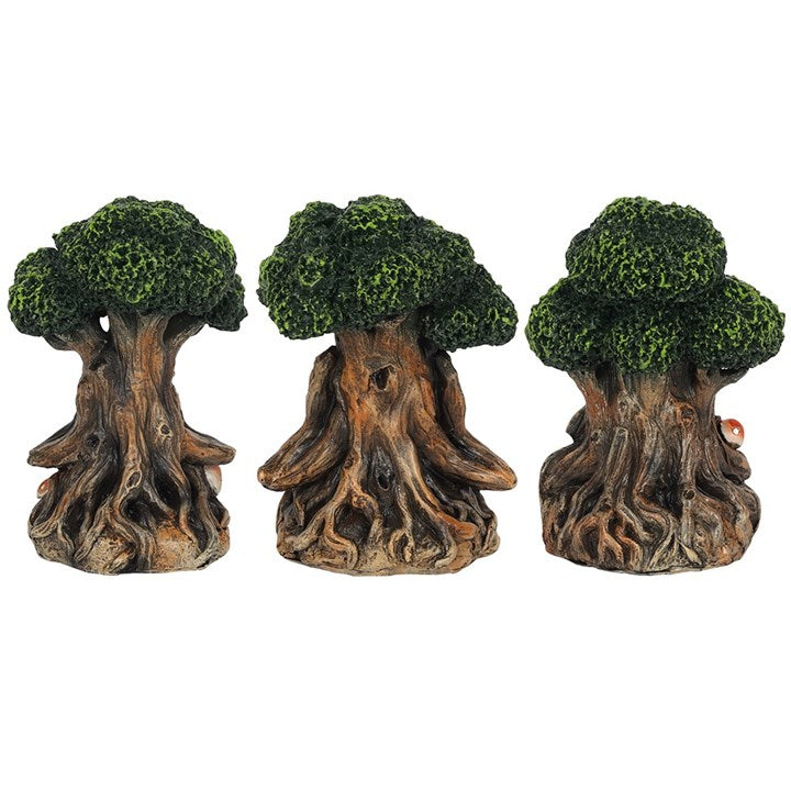 A set of three figurines depicting the Green Man character, each showing one of the "see no evil, hear no evil and speak no evil" saying from behind