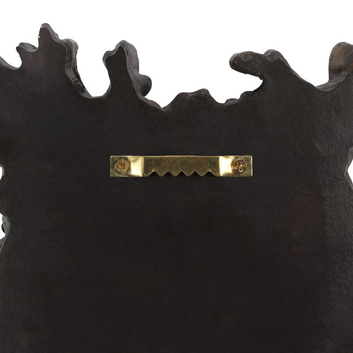 A black plaque from behind showing how to hang it