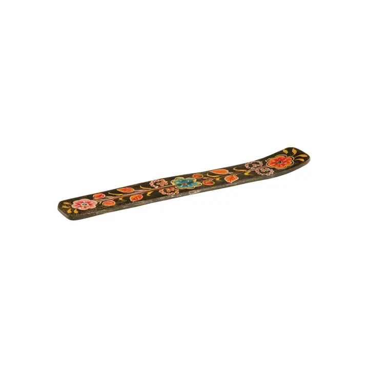 Decorative wooden incense stick holder with floral patterns on a white background