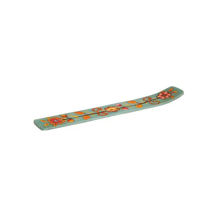 Colourful incense holder with floral patterns on a white surface.