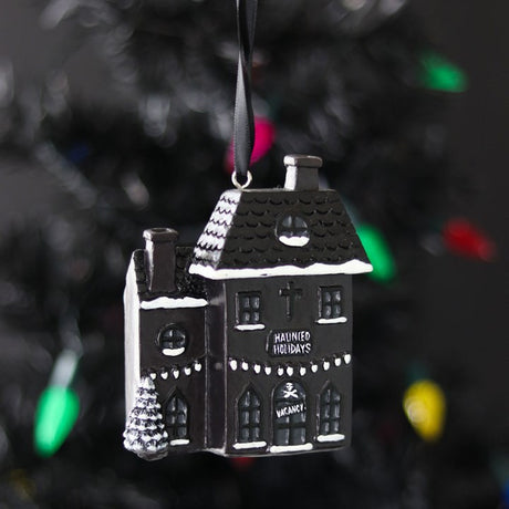 Black "Haunted Holidays" gothic style house on a fabric string for hanging. 