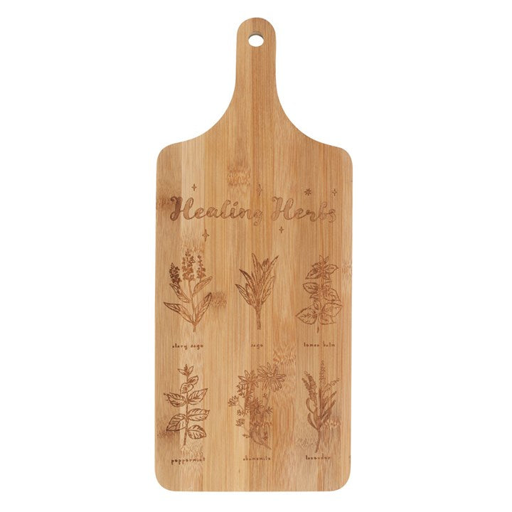 Image shows a "healing herbs" chopping board with etched herb designs on a white background.