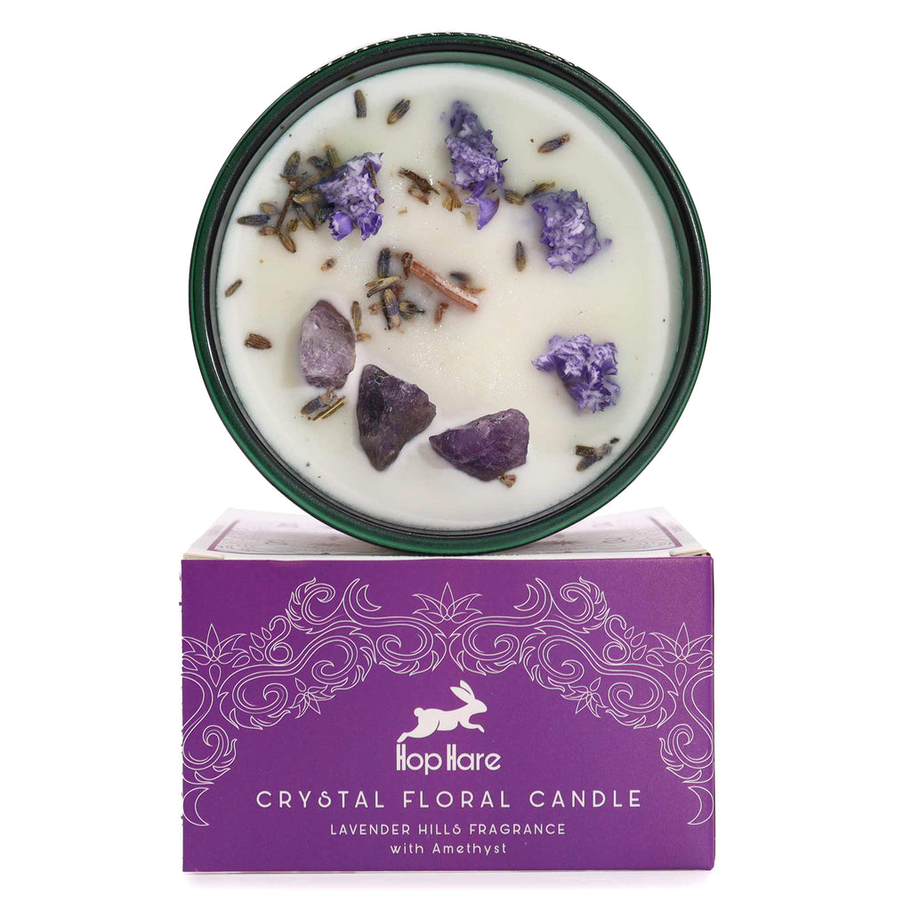 Viewed from above: A green glass candle with lavender flowers and Amethyst gemstones inside. Below is a matching box. 