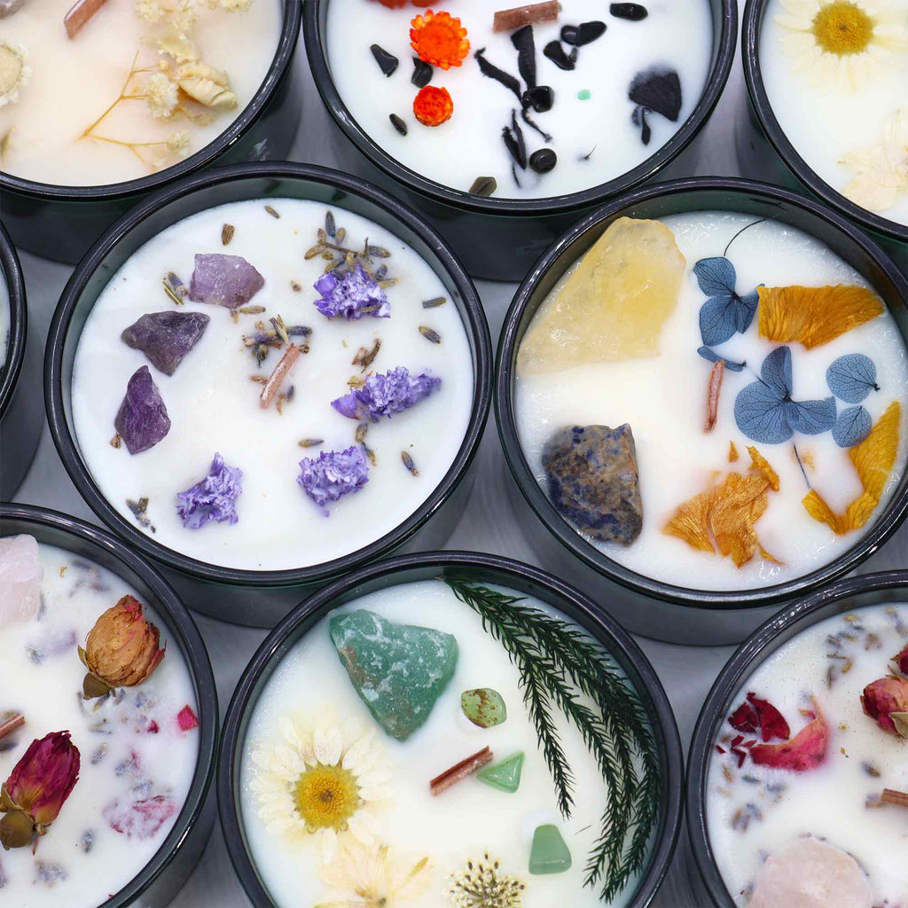 Viewed from above; several green glass candles various flowers and crystals. 