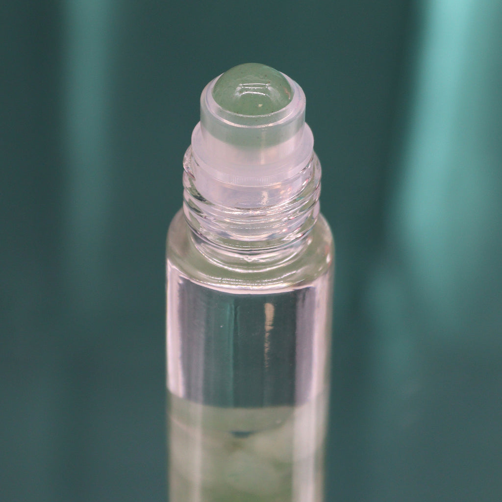 A close up of an essential oil roll on glass tube