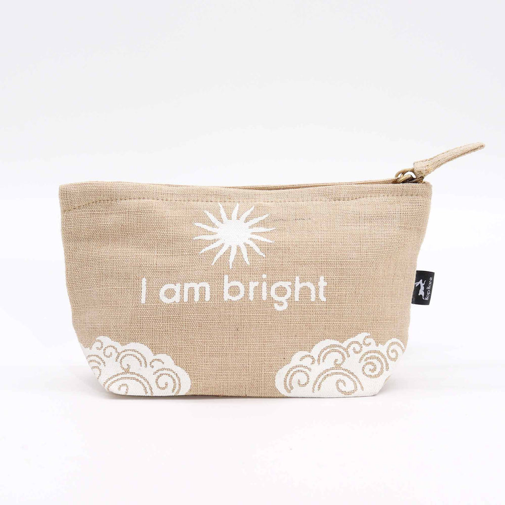 A beige jute pouch with an 'I am bright' affirmation in white. 